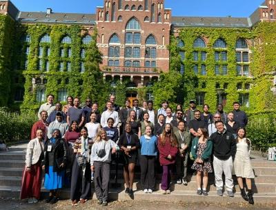 A group of people in front of a university.